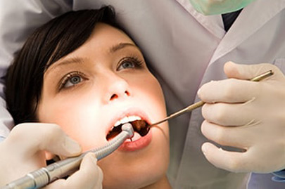 Open female mouth during oral checkup at the dentist